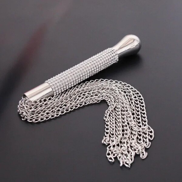 Adult Whip with Diamond Handle Heavy Chain BDSM Flogger on satin bedspread – elegant sensual accessory