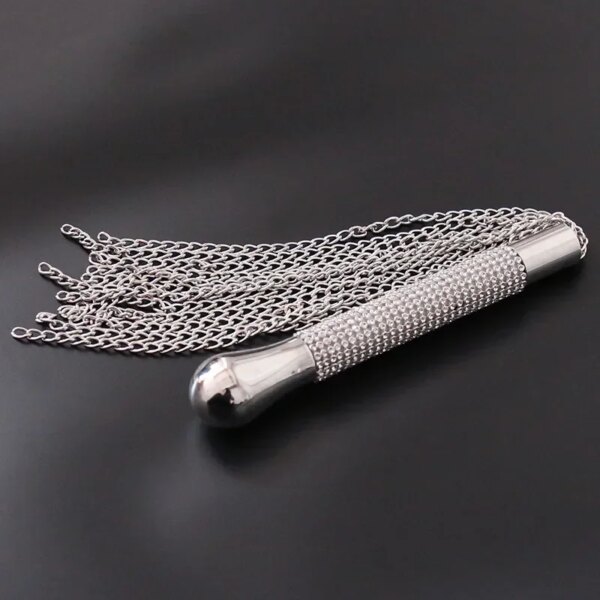Adult Whip with Diamond Handle Heavy Chain BDSM Flogger on satin bedspread – elegant sensual accessory