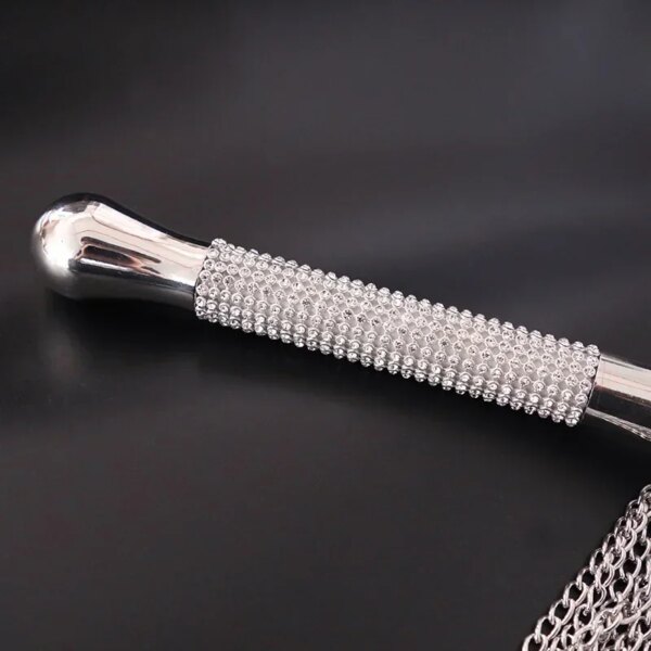 Adult Whip with Diamond Handle Heavy Chain BDSM Flogger on satin bedspread – elegant sensual accessory