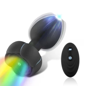 Two black vibrating anal plugs with a wireless remote control for prostate massage.