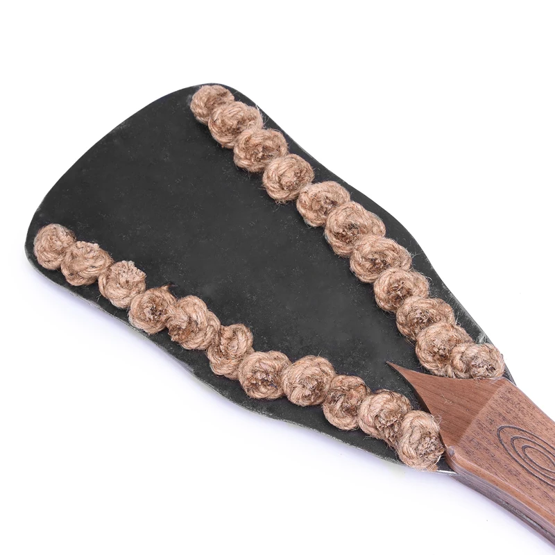 A professional iron plate BDSM spanking paddle alongside a textured hemp rope bondage whip for adult sensory play.