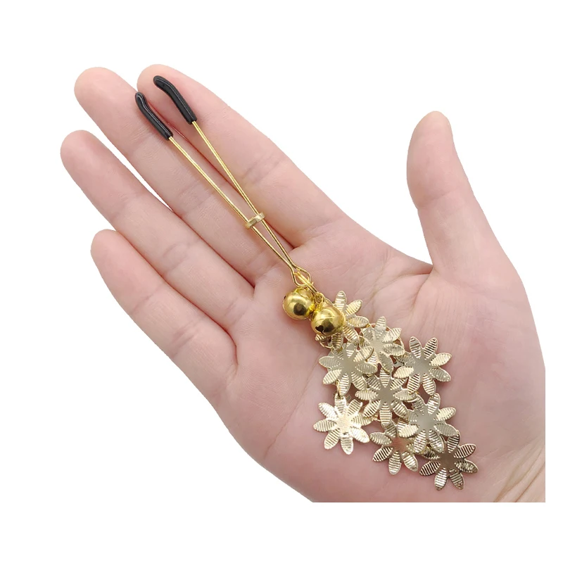 Pair of silver metal nipple clamps featuring white feather charms and small circular bells for sensory SM teasing play.