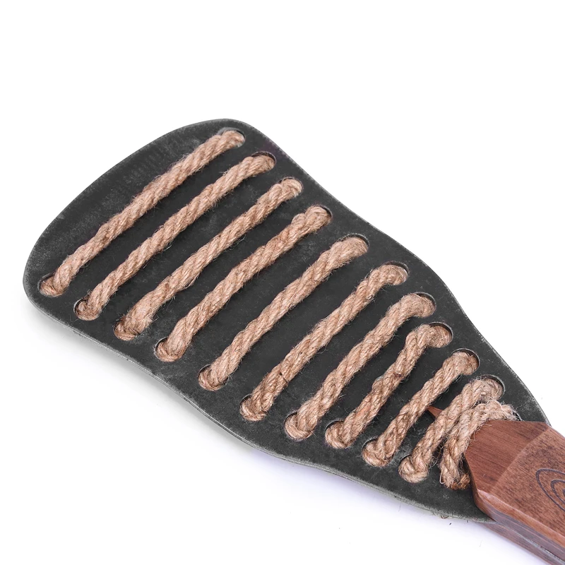 A professional iron plate BDSM spanking paddle alongside a textured hemp rope bondage whip for adult sensory play.