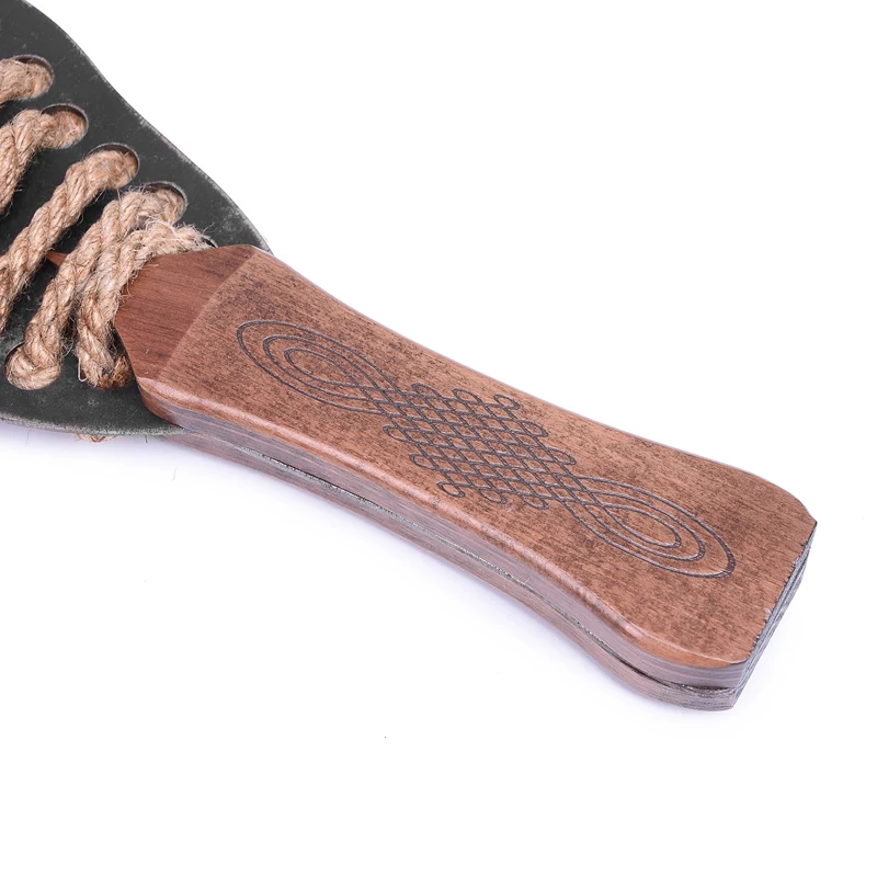 A professional iron plate BDSM spanking paddle alongside a textured hemp rope bondage whip for adult sensory play.