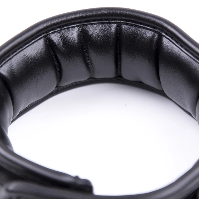 A black leather BDSM collar with a heavy iron chain link and soft sponge interior padding.