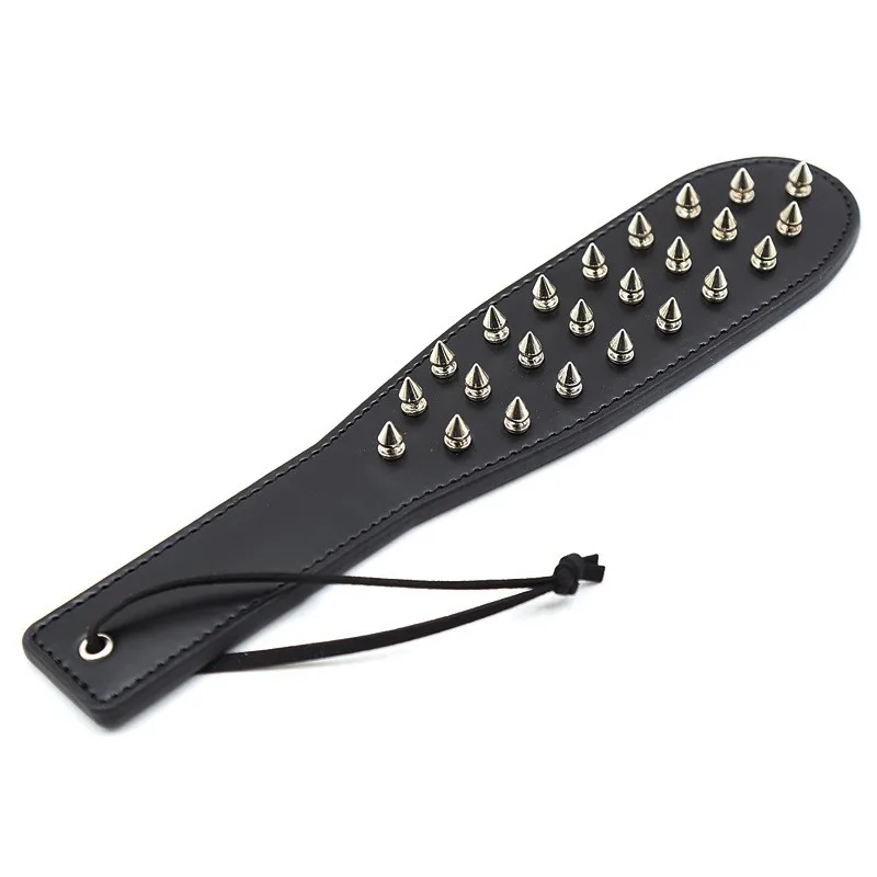 Close-up of a dual-sided black leather spanking paddle and spiked whip for BDSM adult games.