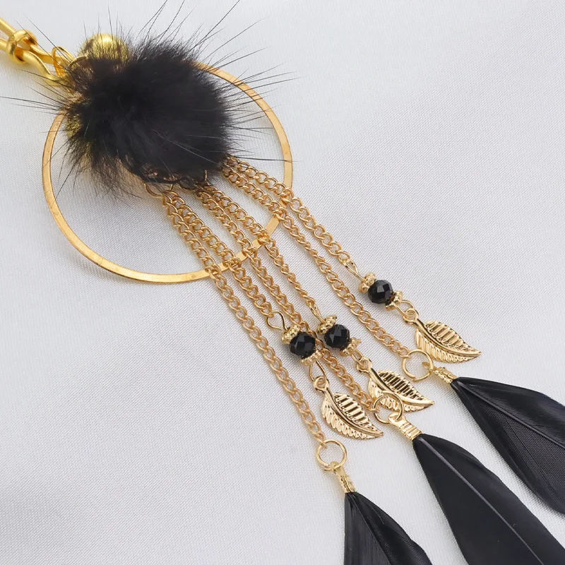Pair of silver metal nipple clamps featuring white feather charms and small circular bells for sensory SM teasing play.