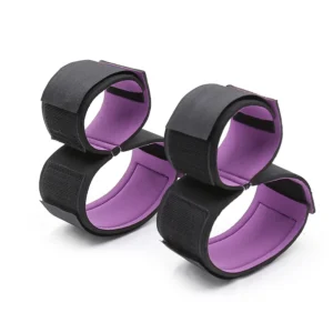 A professional BDSM restraint kit featuring black sponge-padded handcuffs, ankle cuffs, and separate thigh restraints with metal buckles for adult play.