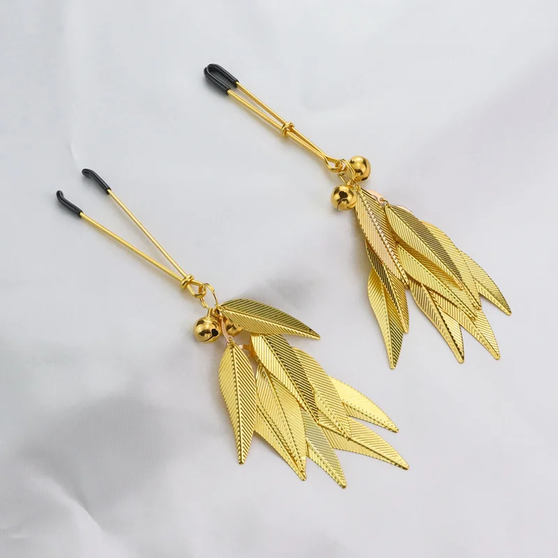 Pair of silver metal nipple clamps featuring white feather charms and small circular bells for sensory SM teasing play.