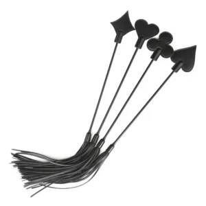 Close-up of a black leather BDSM flogger whip with multi-tail tassels and a textured handle for bondage play.