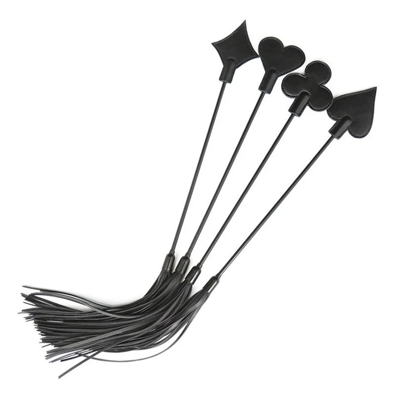 Close-up of a black leather BDSM flogger whip with multi-tail tassels and a textured handle for bondage play.