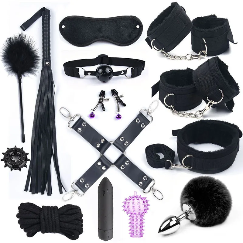 A comprehensive BDSM kit featuring black nylon handcuffs, a sex whip, a mouth gag, and a grey rabbit tail anal plug on a neutral background.