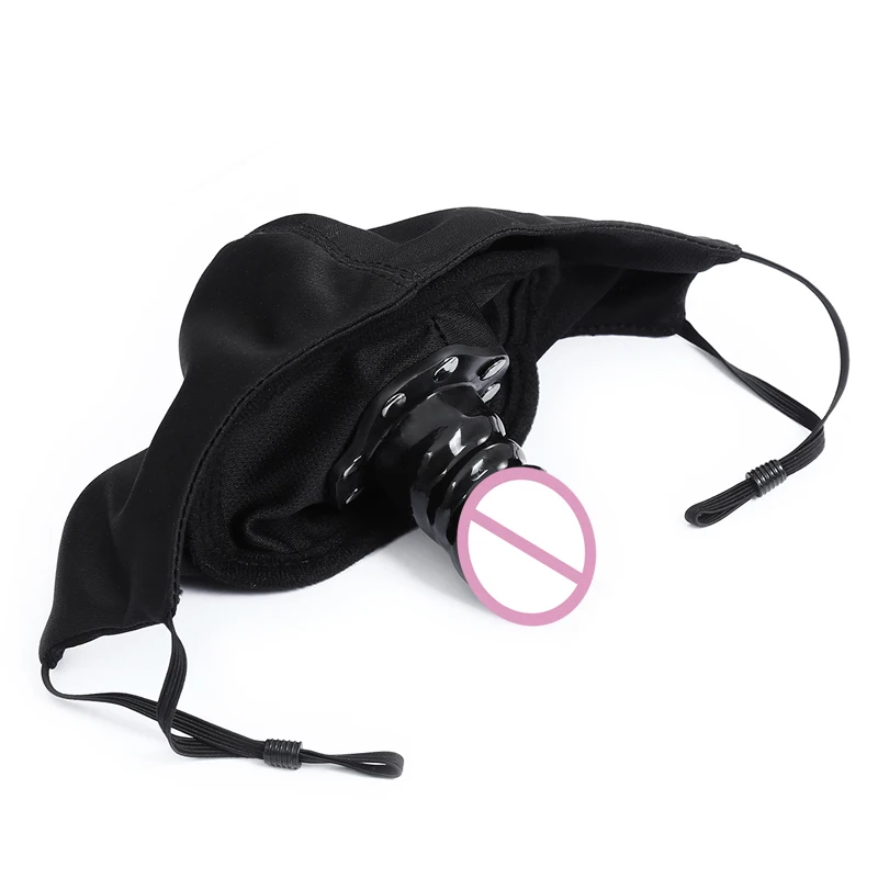 Black bondage mask with open mouth gag and integrated silicone dildo plug for adult play.