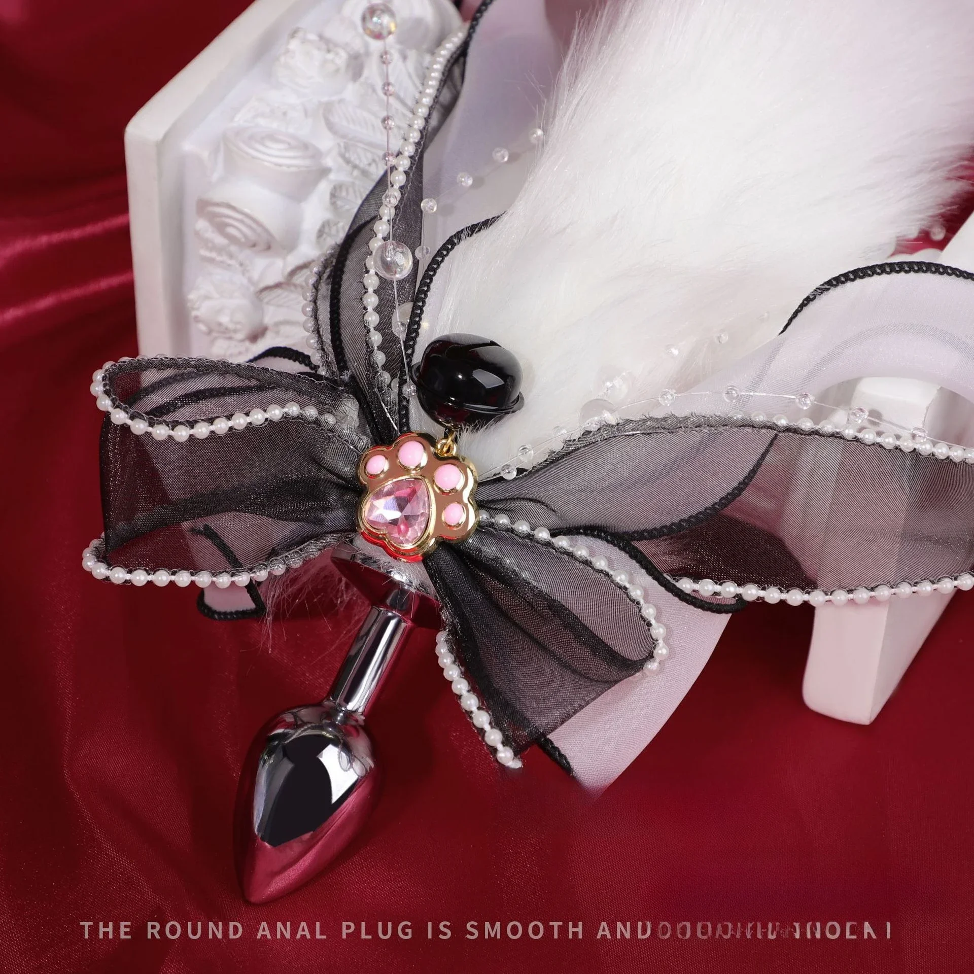 A metal anal plug with a colorful, plush fox tail attachment for erotic adult games.