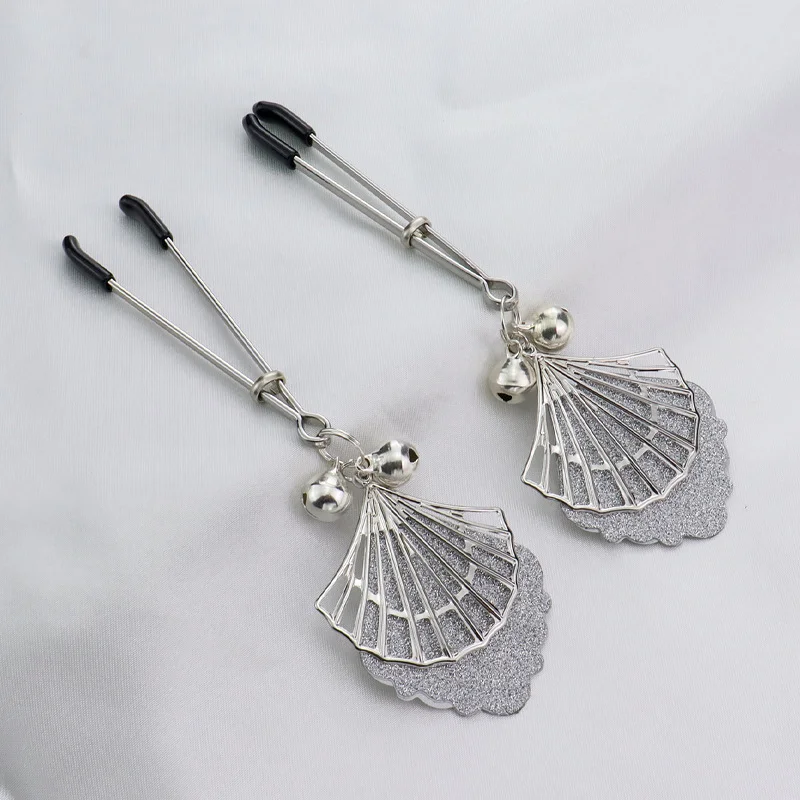Pair of silver metal nipple clamps featuring white feather charms and small circular bells for sensory SM teasing play.