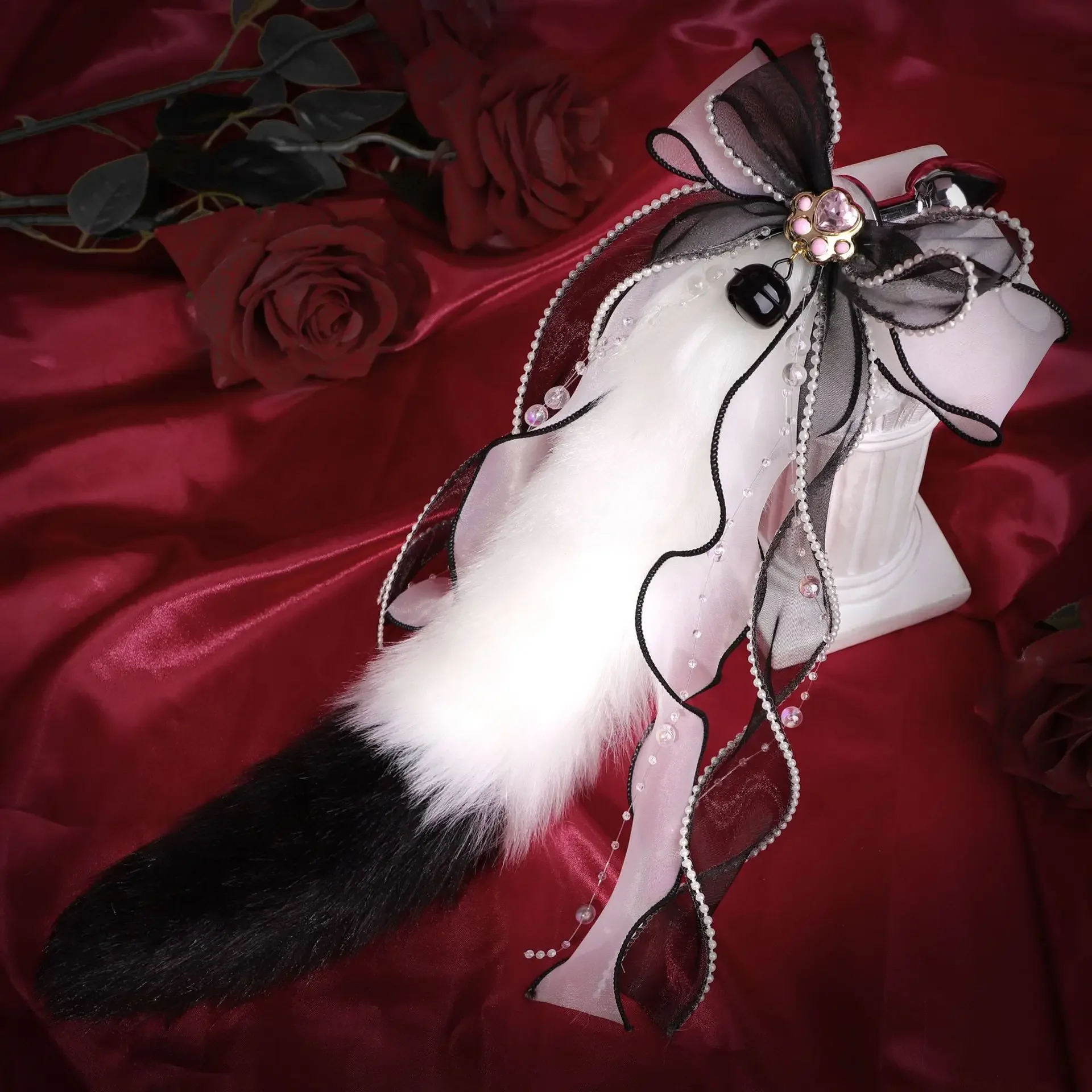 A metal anal plug with a colorful, plush fox tail attachment for erotic adult games.