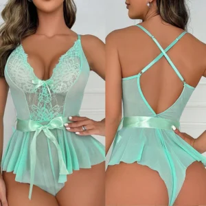 A woman wearing a transparent lace babydoll dress with an open bra design and intricate teddy costume detailing in a plus size fit.