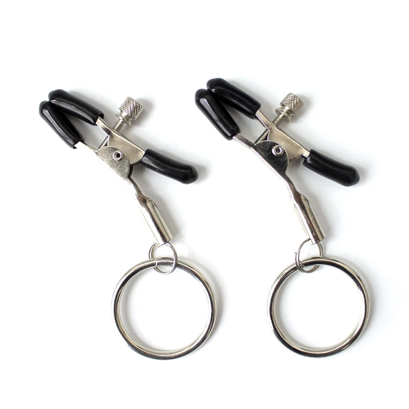 A pair of polished metal hoop nipple clamps for BDSM and fetish sensory play.
