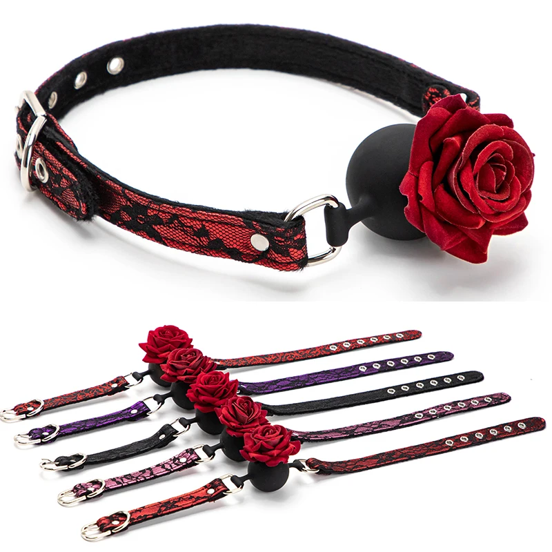 A close-up of a black retro lace pattern rose mouth gag with adjustable straps for BDSM and adult roleplay games.
