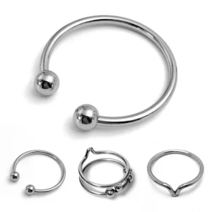Three styles of polished metal penis delay rings in various sizes for male enhancement.