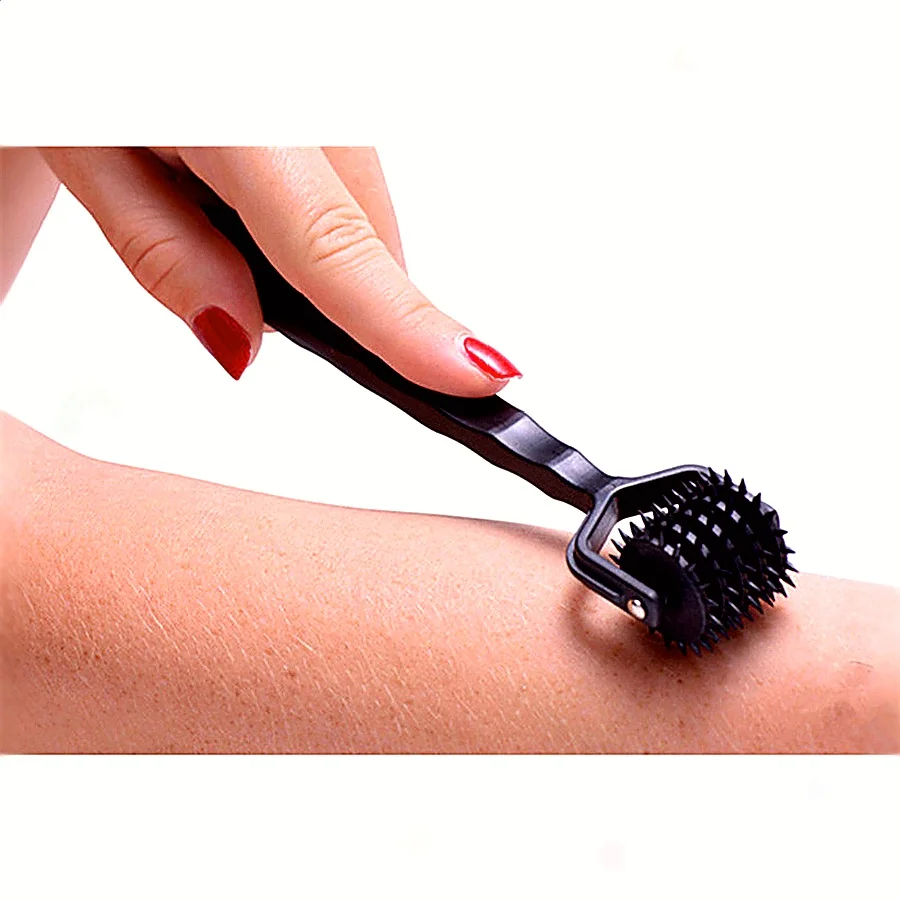 A high-quality BDSM sensory stimulation roller with a spiked wheel and ergonomic handle for adult couple games.