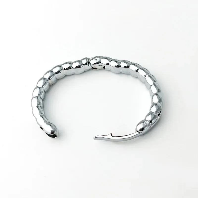 High-shine metal penis locking ring for men shown against a neutral background.