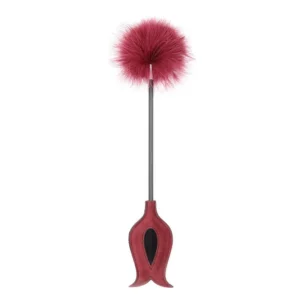 A black fetish teasing stick featuring a soft erotic tickle feather on one end and a leather punish spank whip on the other for sensory adult play.