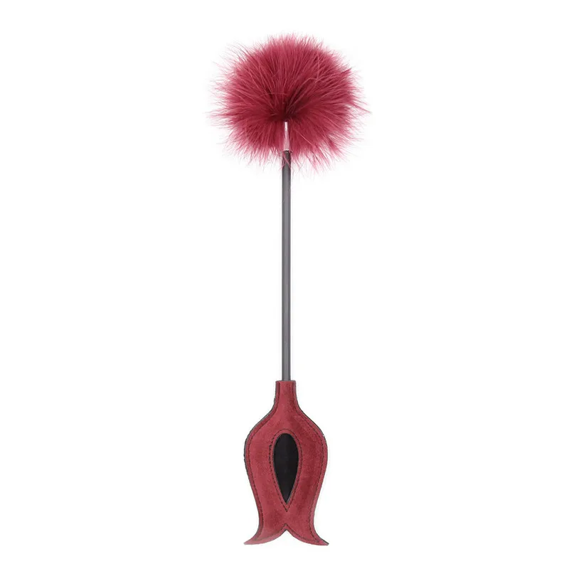 A black fetish teasing stick featuring a soft erotic tickle feather on one end and a leather punish spank whip on the other for sensory adult play.