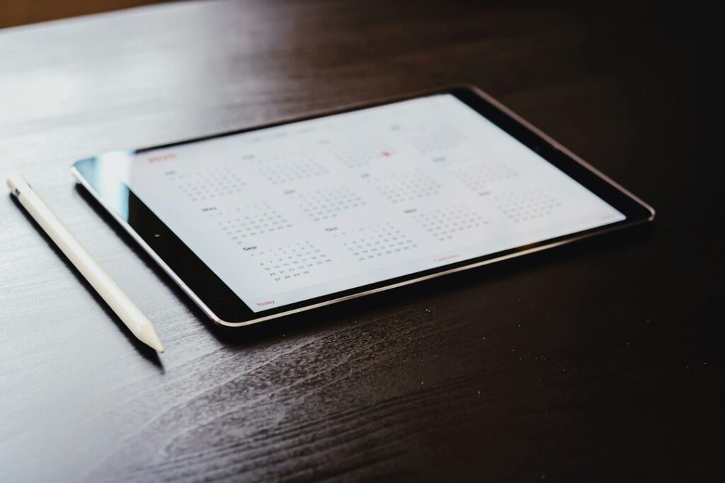 iPad displaying a digital calendar app with an Apple Pencil, representing AI-assisted planning and weekly organization
