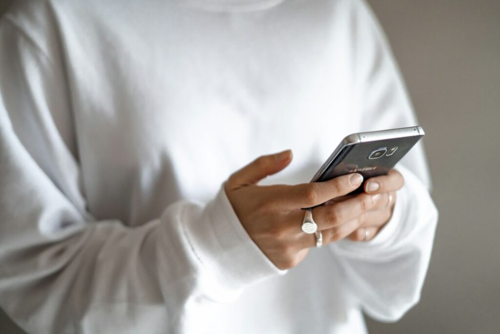 Person using a smartphone to manage tasks and save time with an AI productivity app