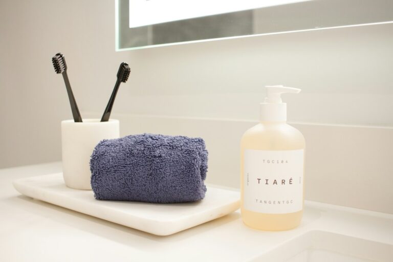 Clean minimal bathroom counter with soap dispenser and folded towel representing hygiene and self-care