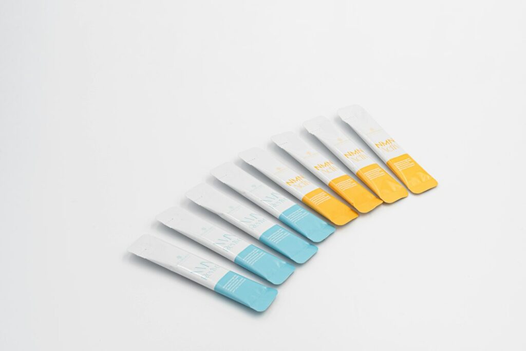 Fan of clean white test strips with blue and yellow color indicators, representing pH and osmolality testing for lubricant safety
