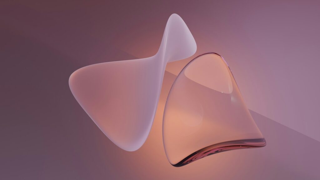 Abstract smooth flowing glass-like shapes with soft lighting, representing the non-porous smooth surface of body-safe silicone materials